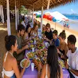 Tourist feeding a banana to a ring-tailed lemur at Lemuria Land Park in Madagascar