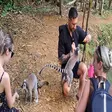 Tourist feeding a banana to a ring-tailed lemur at Lemuria Land Park in Madagascar